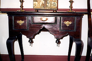 Detail of Persian arched skirt, pendants, and double-moulds around drawers