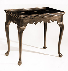 Tray top tea table with calloped skirt on cabriole legs with pad feet