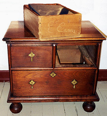 Diminutive chest of drawers on ball feet, signed E. Evans