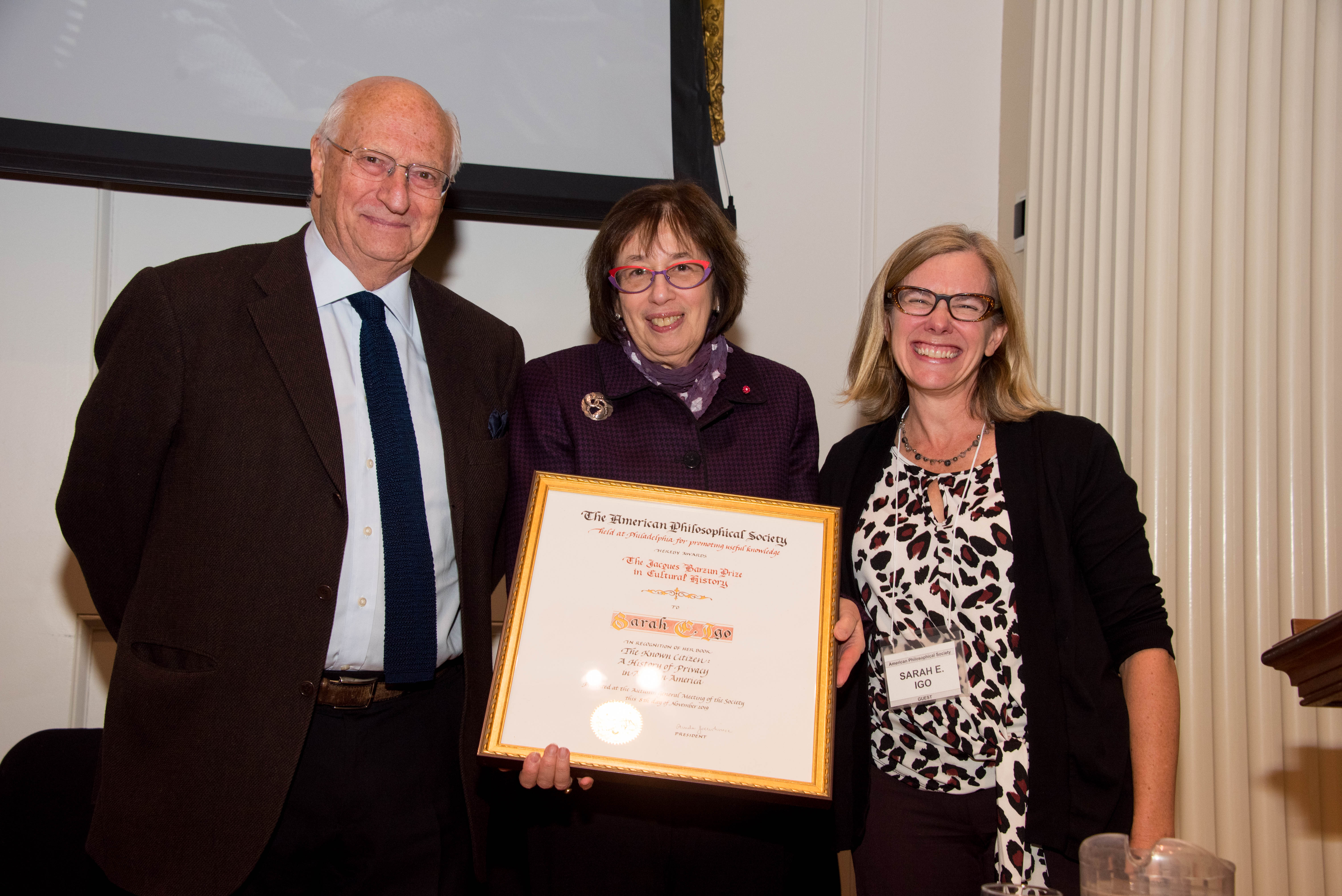 Linda Greenhouse holds the Jacques Barzun Prize certificate, between Michael Wood and Sarah Igo