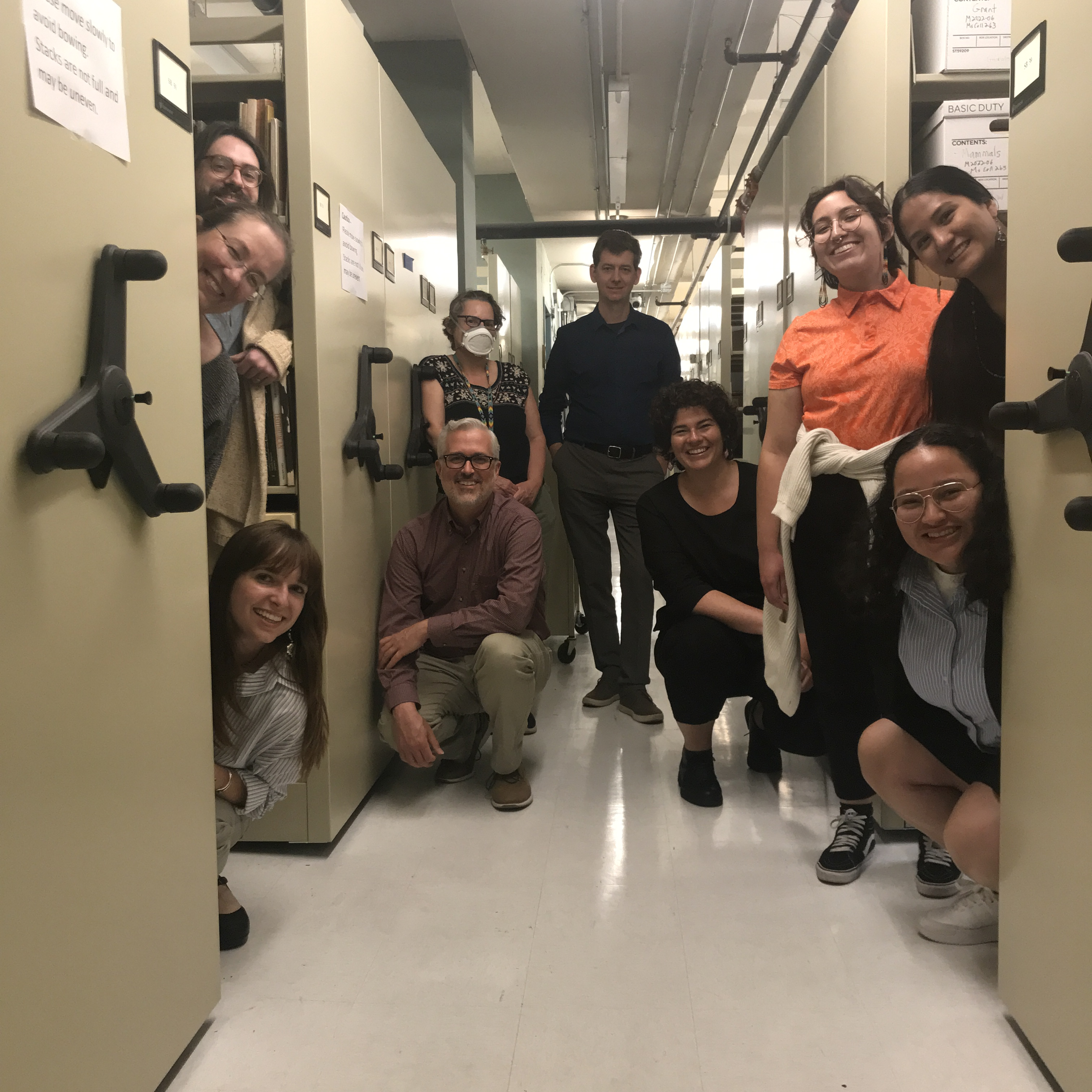 Photo of 2023 NASI interns, APS staff, and visitors inside the collections area