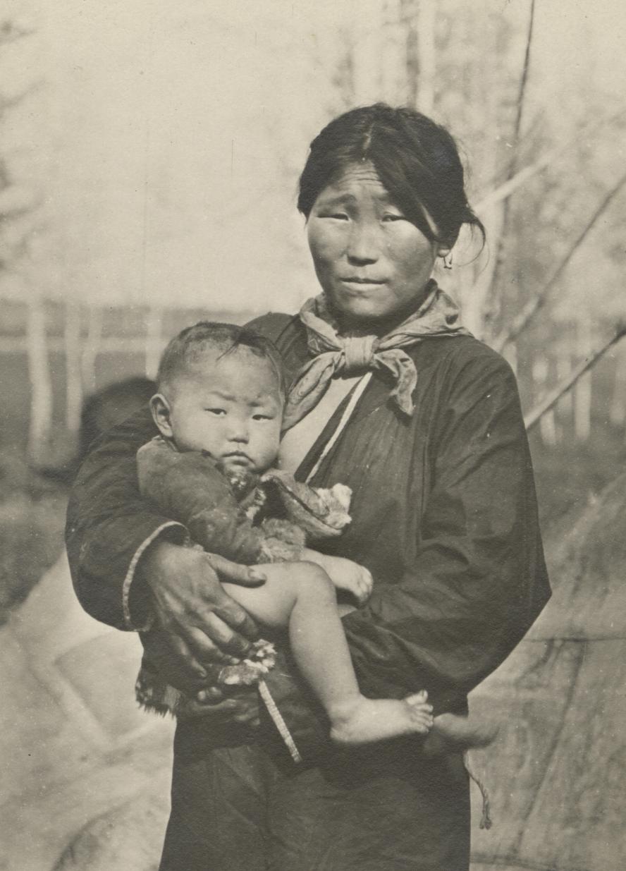 photo of woman holding small child