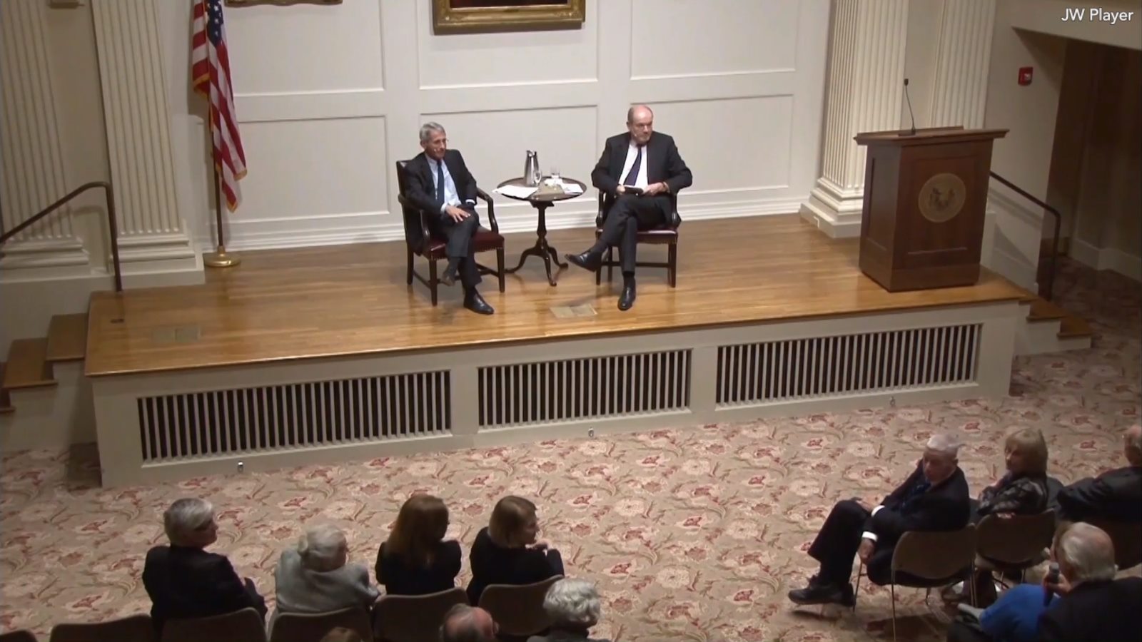 two men on stage in auditorium