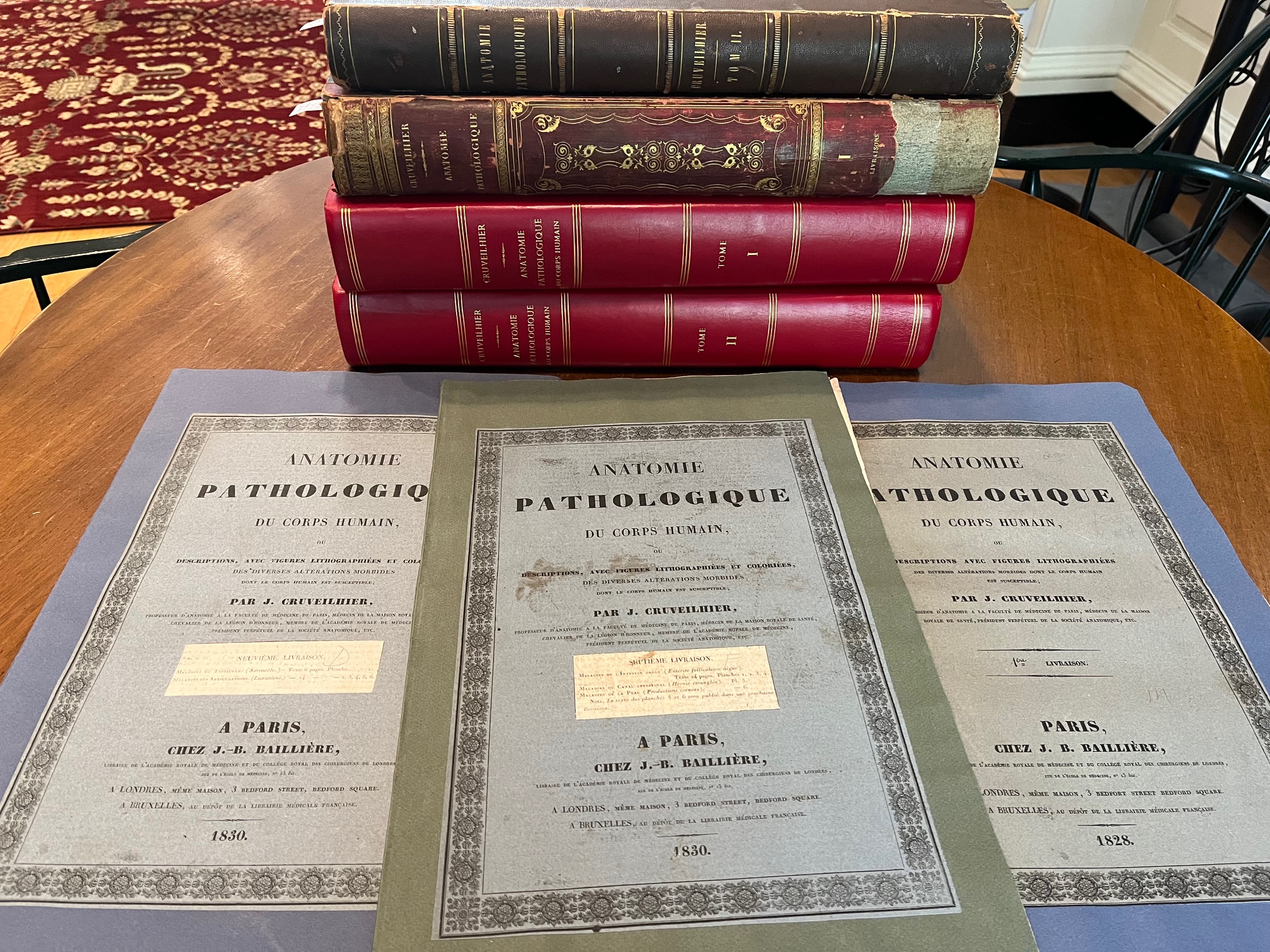 photo of array of single pages plus stack of bound volumes
