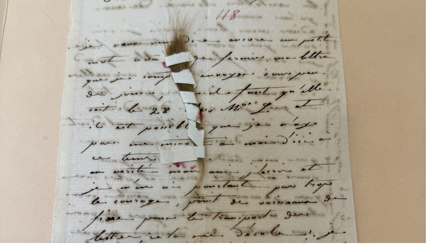 photo of manuscript letter with lock of hair on top