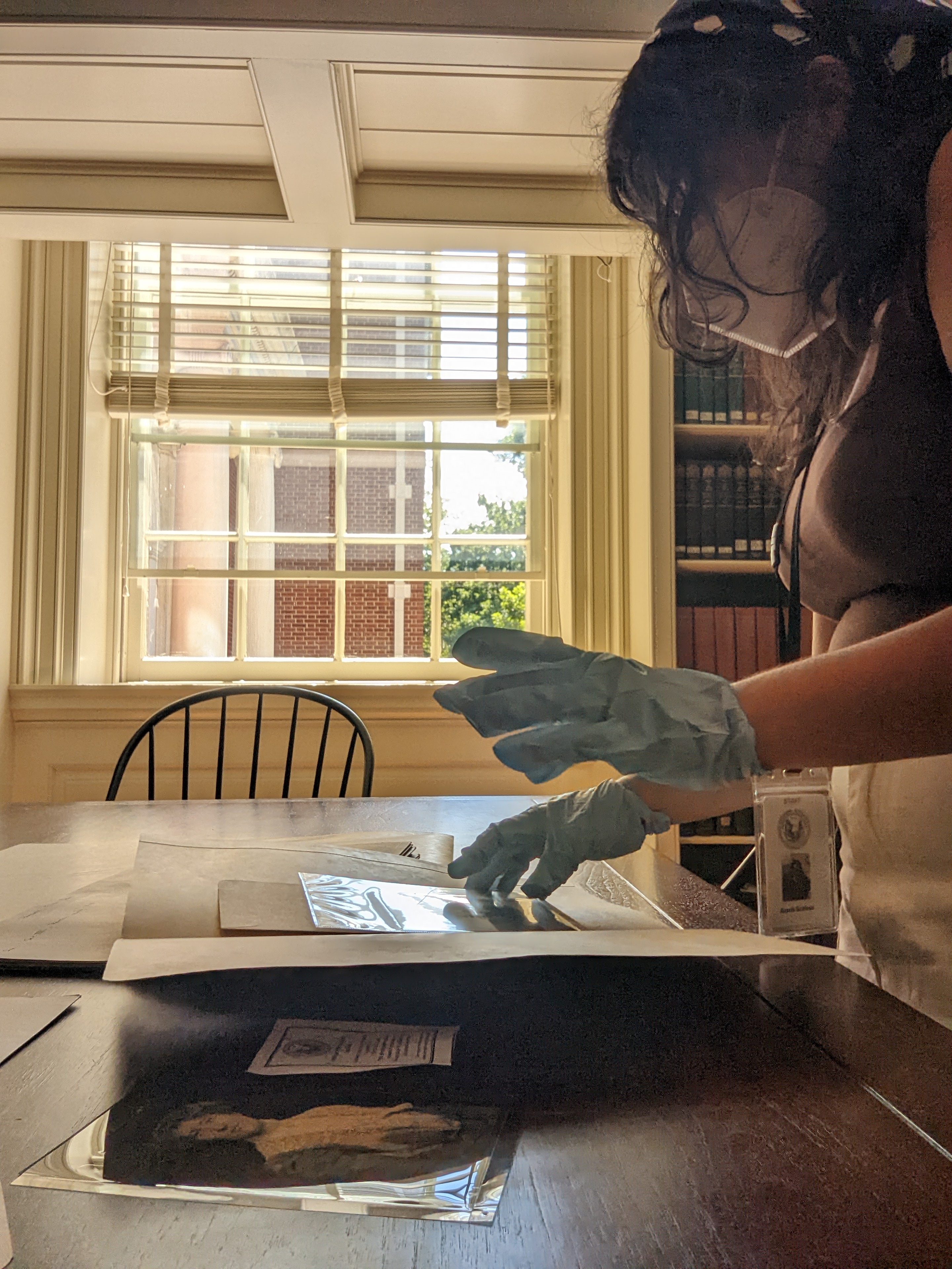 photo of Alexis working with materials in the Reading Room