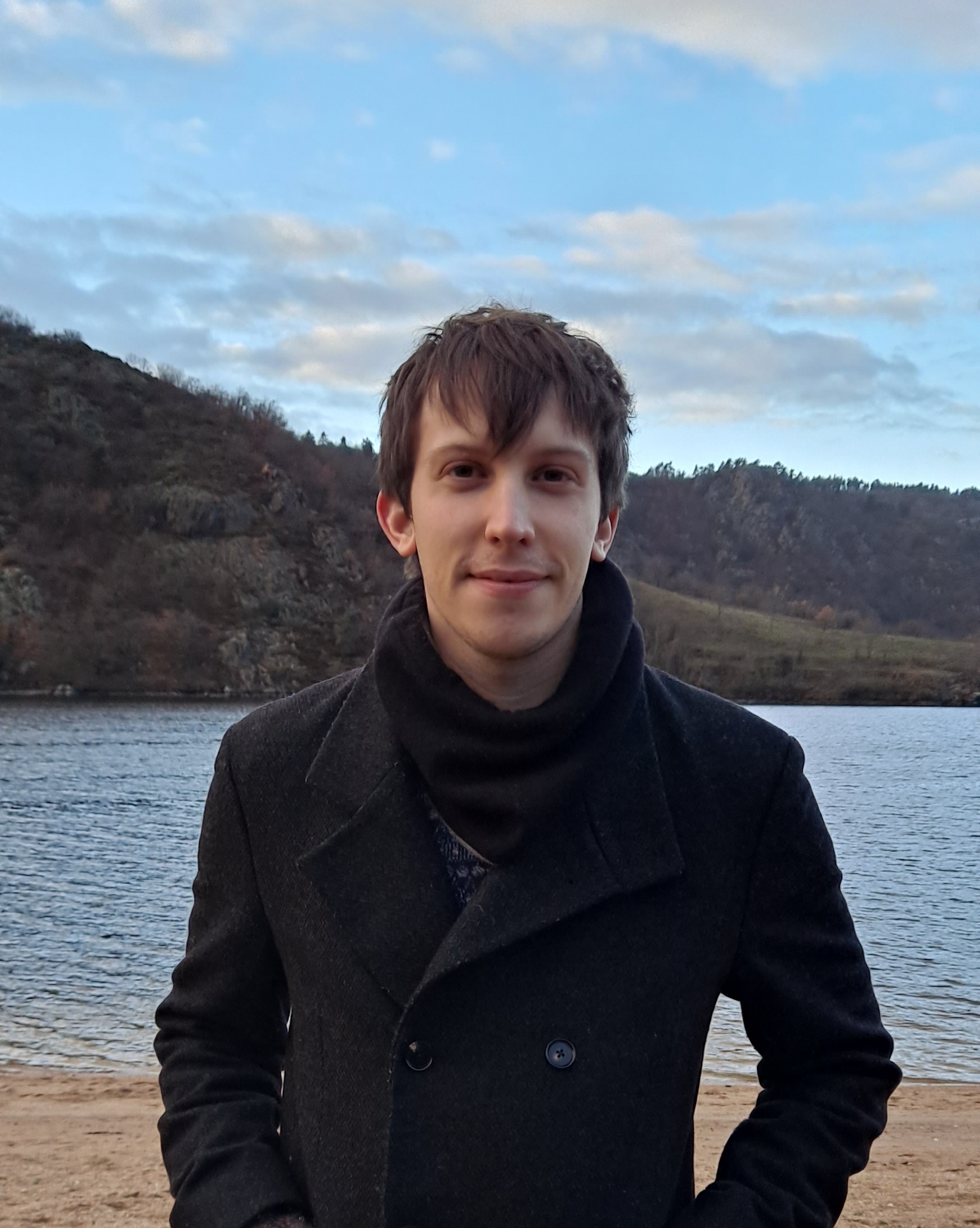 photo of man standing in front of body of water