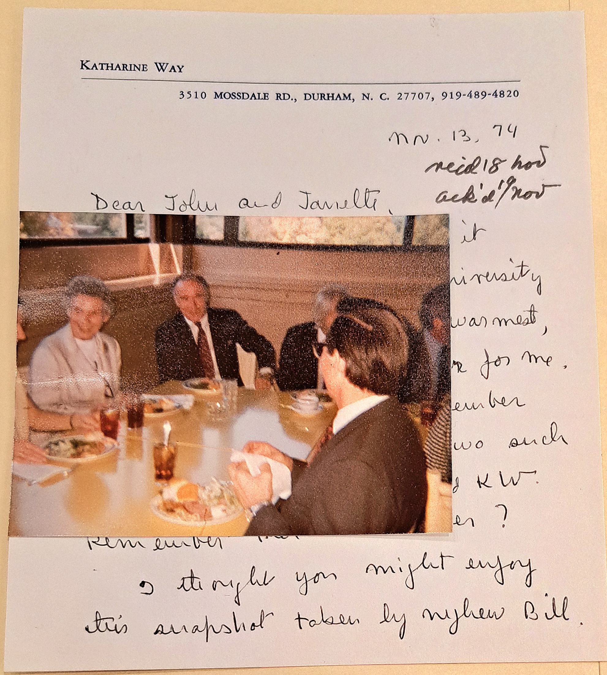 photo of group of 7 sitting around a table eating, sitting on top of handwritten letter