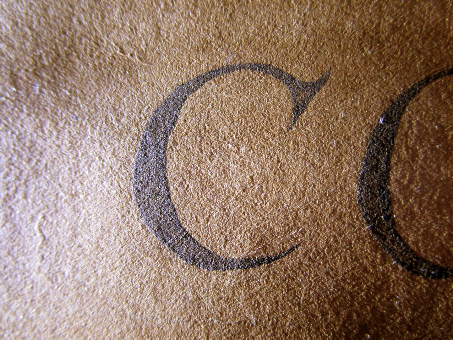 close up of "C" printed on paper
