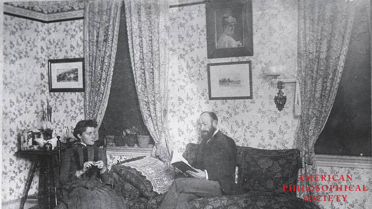 Reading a book in a parlor