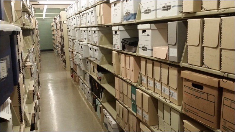 Image of aisle of shelves of archival storage boxes
