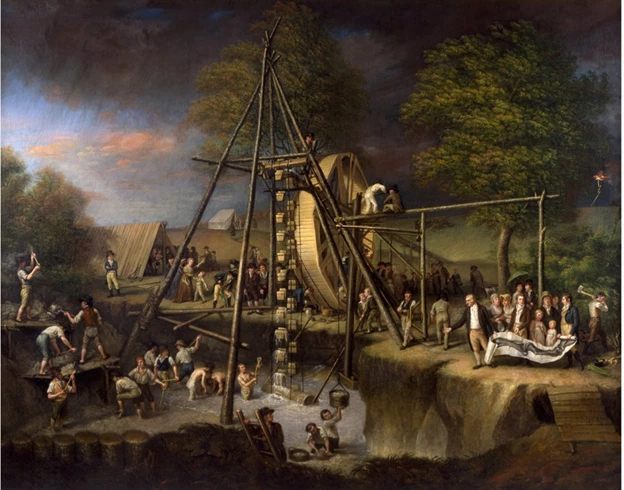 A large wheel-like contraption pulls buckets of liquid out of the ground.
