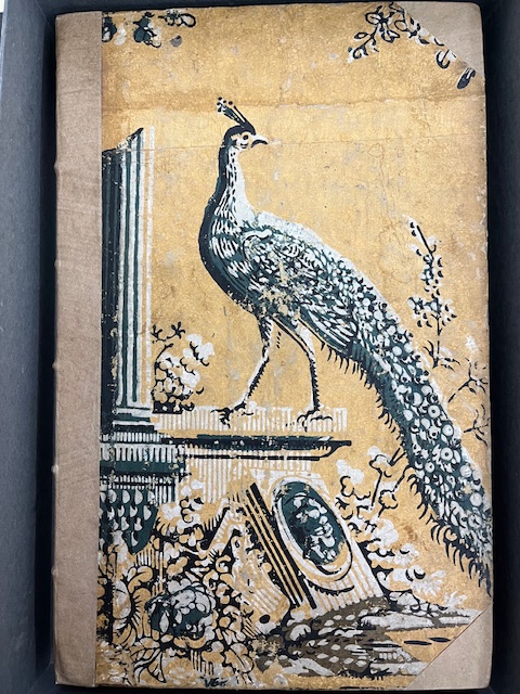Black and white painting of a peacock perched on a building with pillars on the cover of a book.