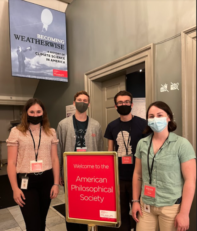 photo of four guides standing outside exhibition space