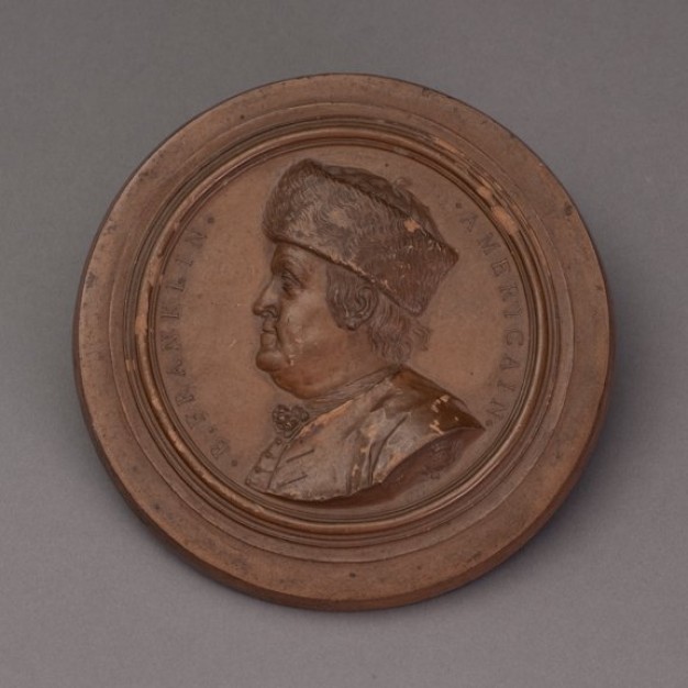 photo of a medallion with a profile portrait of Benjamin Franklin
