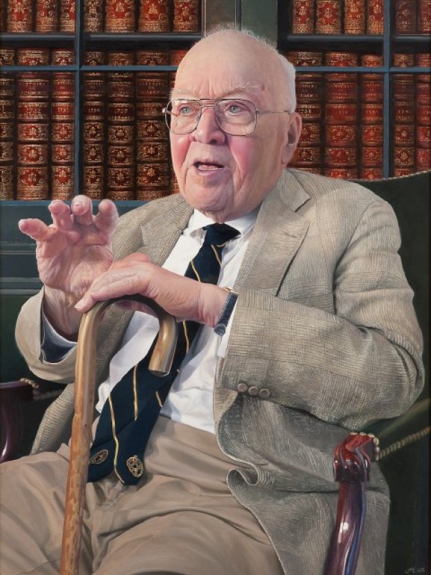 photo of Whitfield Bell seated in front of bookshelves