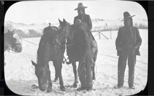 black and white photo of three people and three horses