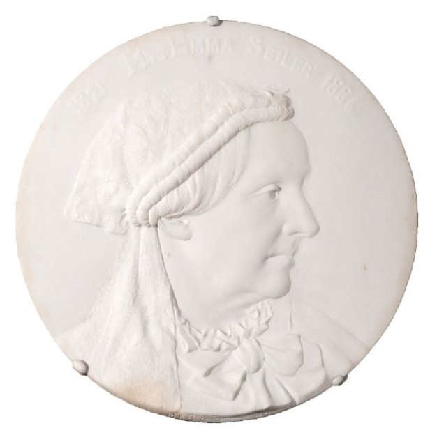 white medallion of profile of Seiler