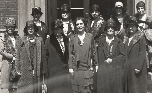 black and white photo of eleven women