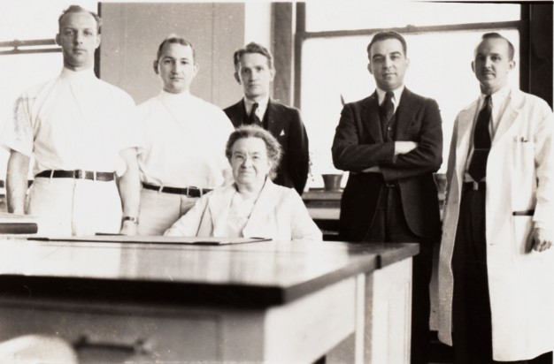 black and white photo of Florence Sabin seated, with five men standing behind her