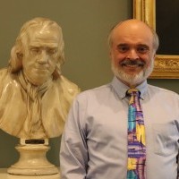 man next to bust of Franklin
