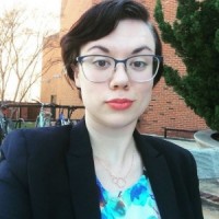 woman with short hair and glasses