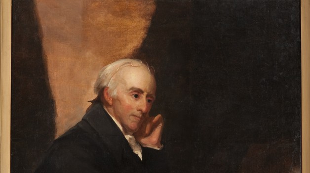 painting of man in black robes seated at desk