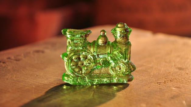 green train made of clear toy on a table