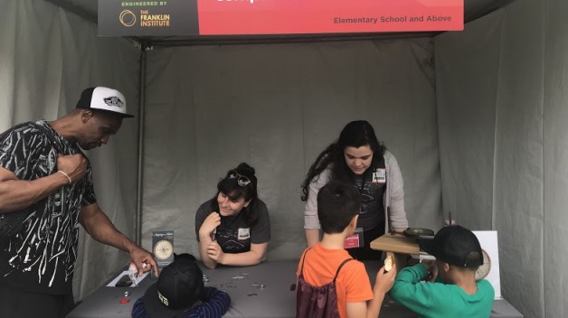 guides leading activity with children at science festival
