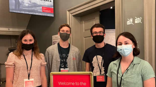 photo of four guides standing outside exhibition space