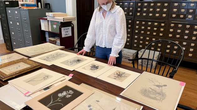 photo of Anna Guerrero in front of botanical images