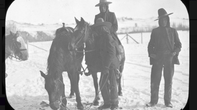 black and white photo of three people and three horses