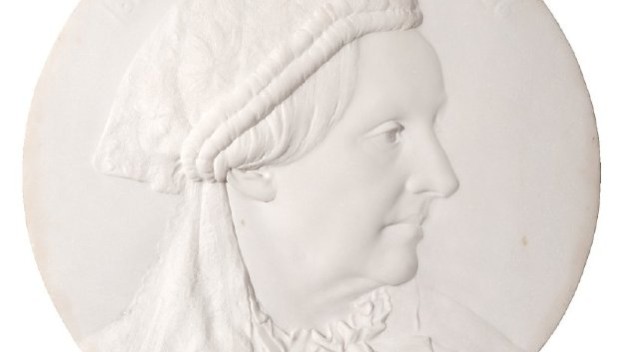 white medallion of profile of Seiler
