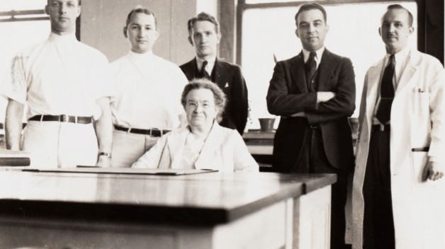 black and white photo of Florence Sabin seated, with five men standing behind her