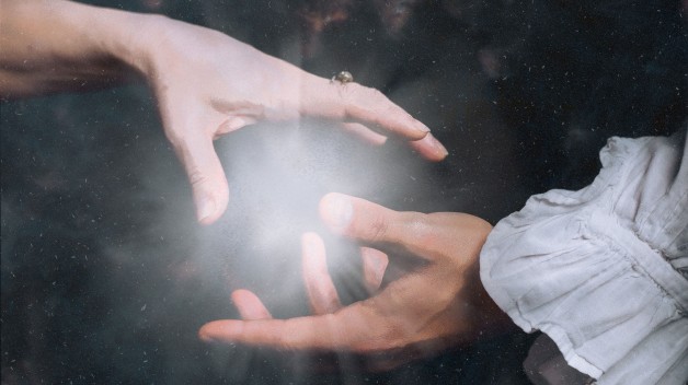 two hands reaching for one another