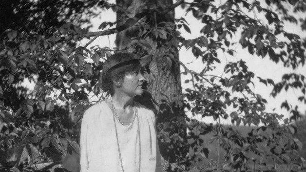 black and white photo of Elsie Clews Parson standing amid trees