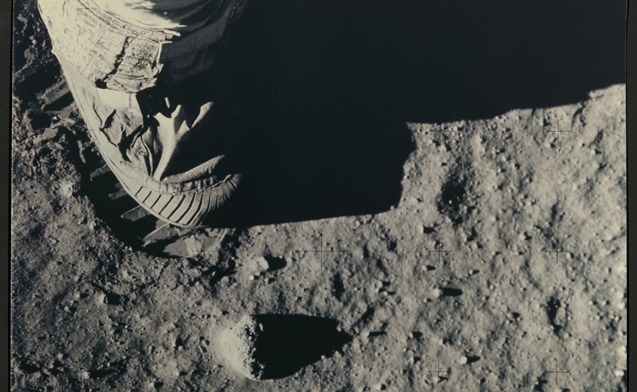 boot of spacesuit and footprint on moon