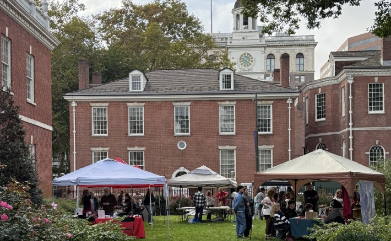 a picture taken from jefferson garden looking over various tents and table with philosophical hall in the background