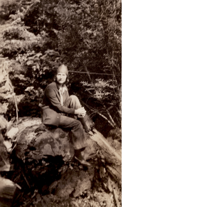 Mary R. Haas sitting on log