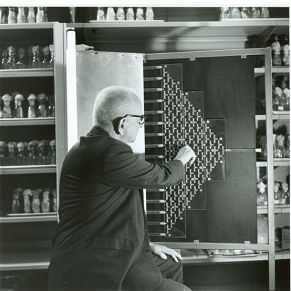 black and white photograph of a man (Dobzhansky) with his back to the camera working with a fly maze