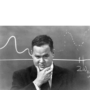 photograph of a man (John Tukey) in front of a blackboard