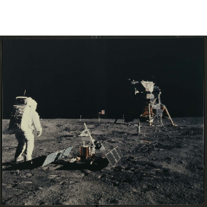 photograph of person wearing spacesuit walking on the moon with spaceship and gear in background
