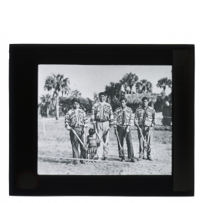 Black-and-white glass lantern slide portrait of Seminole stickball players.