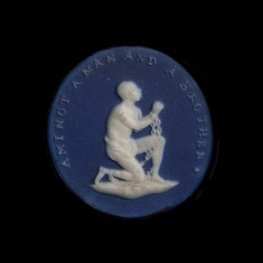 Blue ceramic medallion with white image of kneeling enslaved man in chains with text reading "Am I not a man and a brother?"