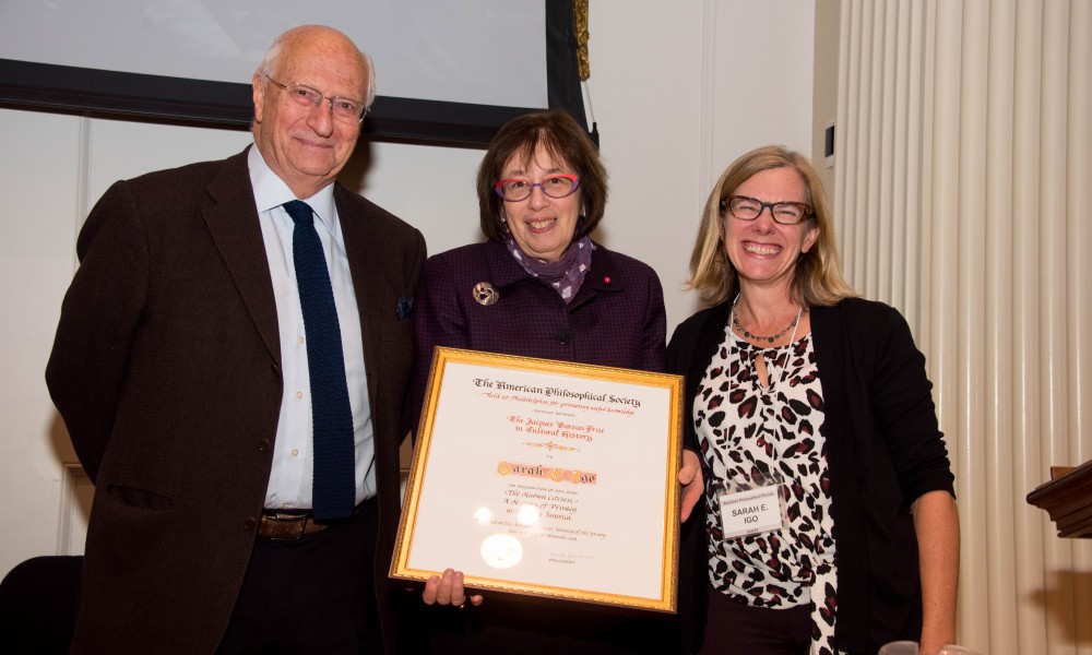 Linda Greenhouse holds the Jacques Barzun Prize certificate, between Michael Wood and Sarah Igo