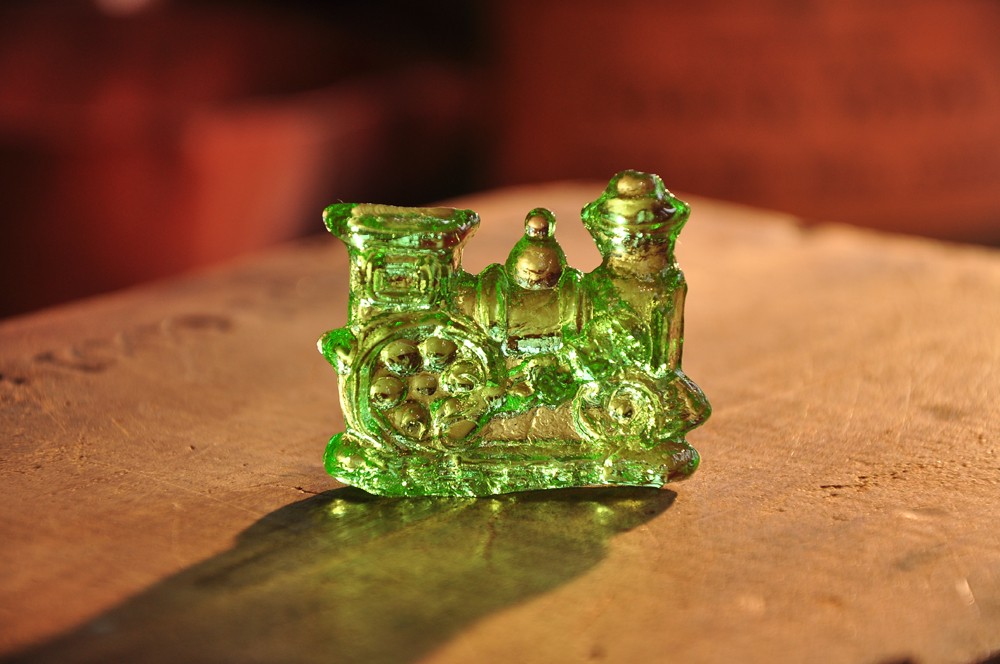 green train made of clear toy on a table