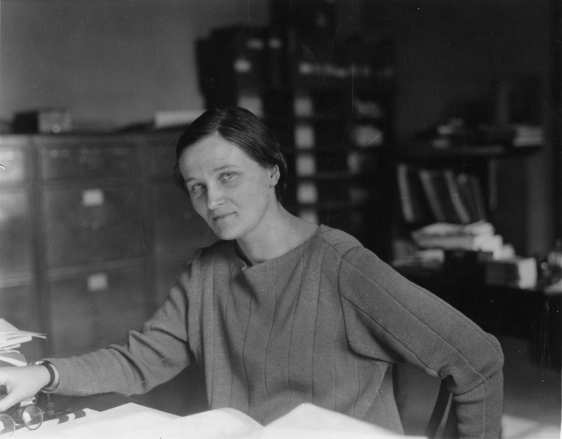 Image of a woman sitting at a table