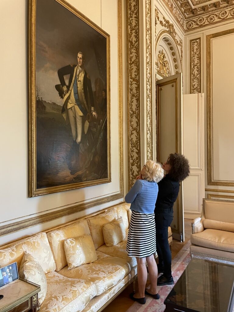 Carol Soltis and Emily Macdonald-Korth looking at Washington portrait