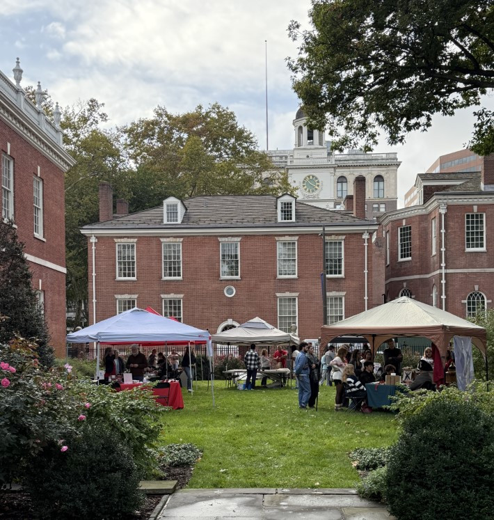 a picture taken from jefferson garden looking over various tents and table with philosophical hall in the background