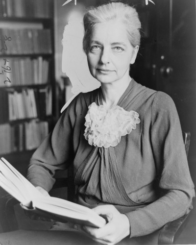 black and white photograph of a woman holding a book 